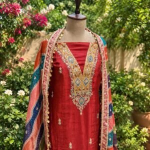 Maroon unstitched shimmer tissue suit with colourful embroidery paired with Banarsi dupatta