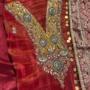 Maroon unstitched shimmer tissue suit with colourful embroidery paired with Banarsi dupatta